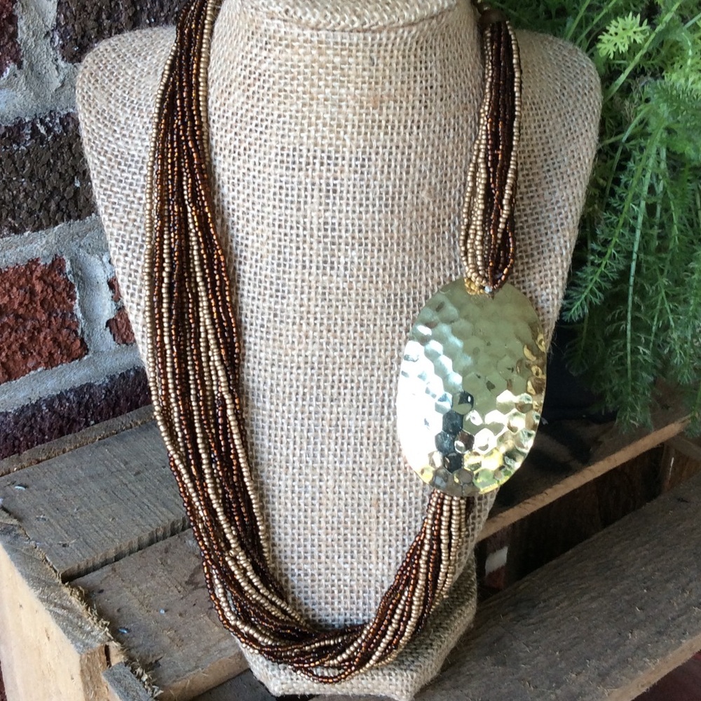 Multi strands of brown and gold tone beads.